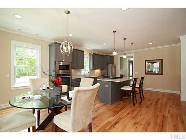 610 Chamberlain Street Raleigh, NC 27607 - Photo 5 of 25 The heart of the home, open to the breakfast area and living room. Custom cabinets, high end granite and appliances, tumbled brick backsplash.