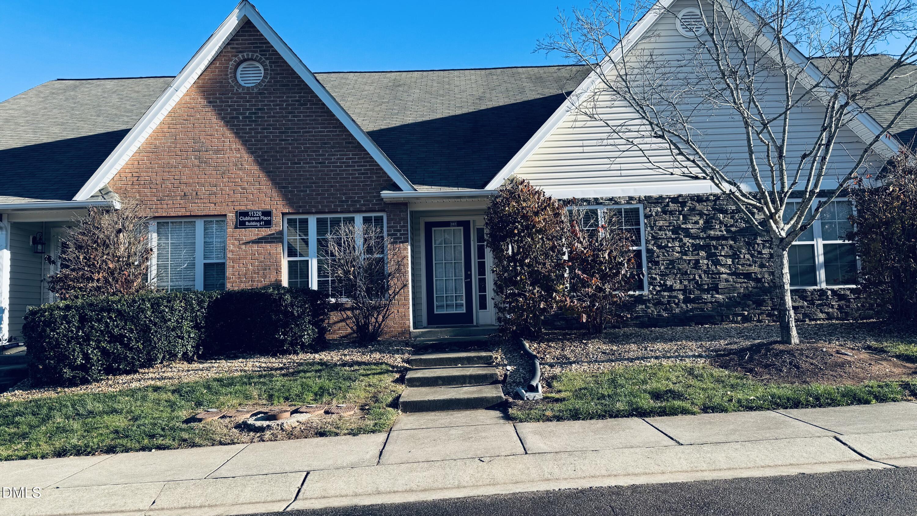 11320 Clubhaven Place, Unit 103 Raleigh, NC 27617 - Photo 1 of 13 a front view of a house with garden