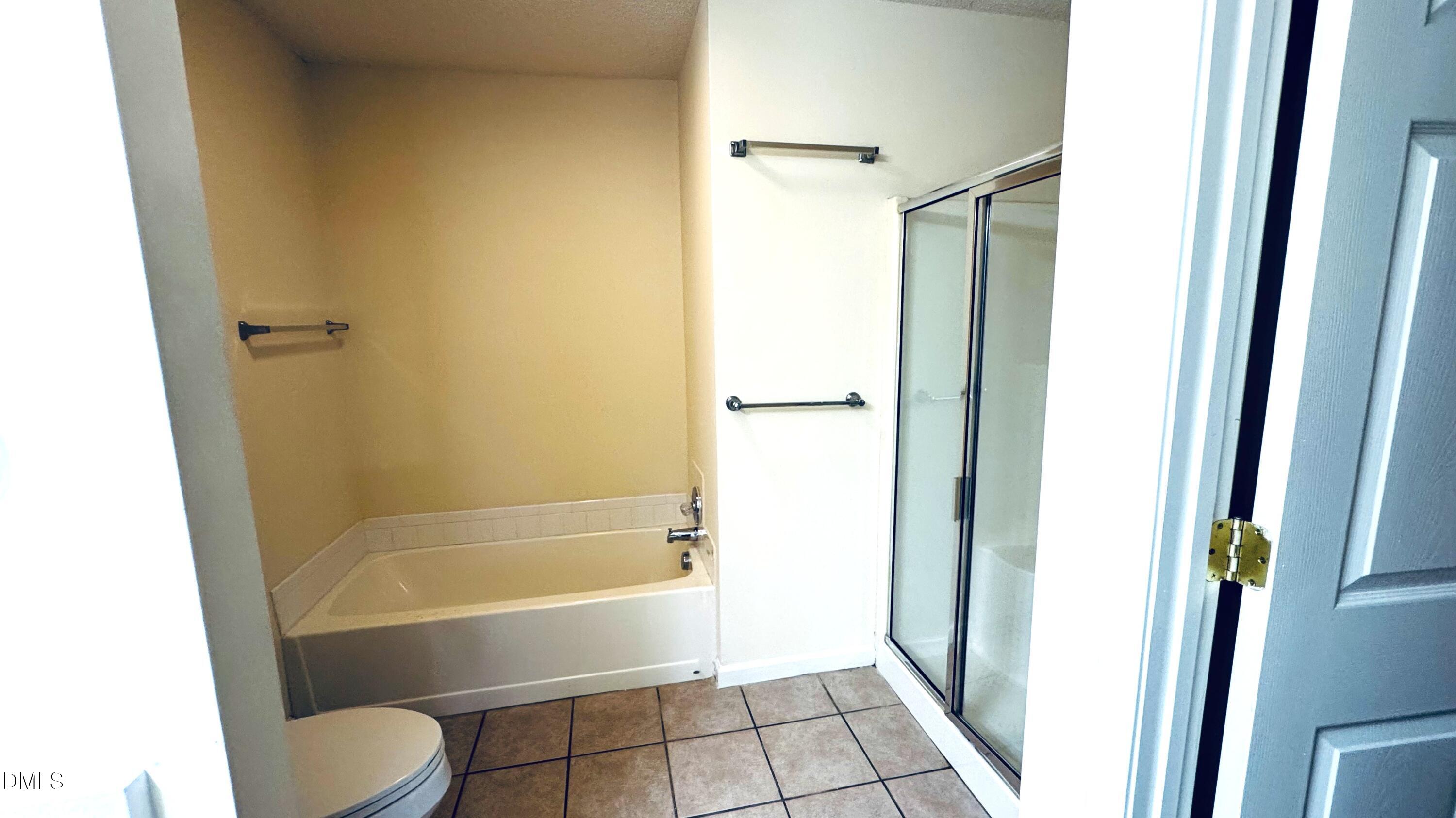 11320 Clubhaven Place, Unit 103 Raleigh, NC 27617 - Photo 10 of 13 a bathroom with a tub and shower
