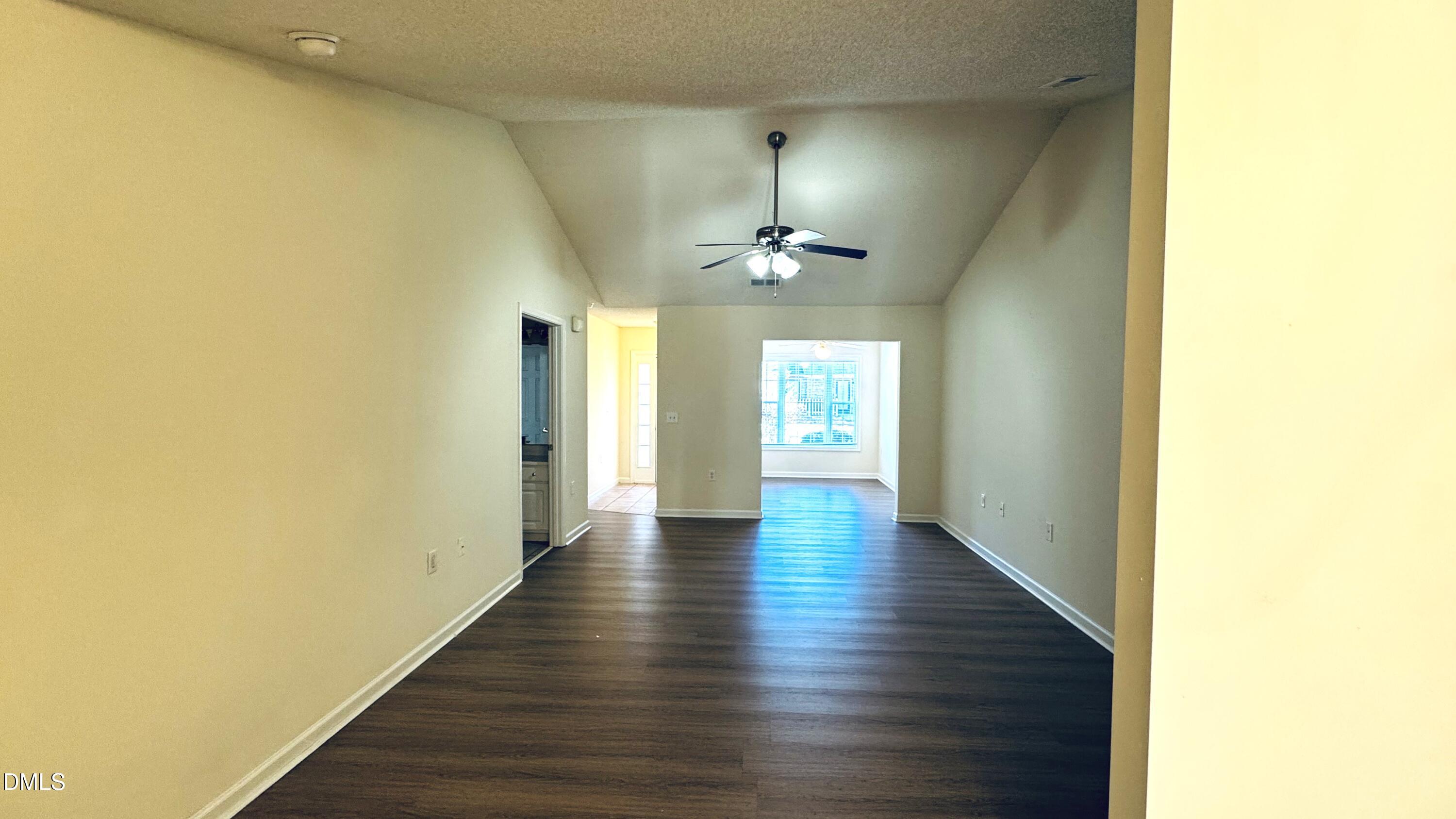 11320 Clubhaven Place, Unit 103 Raleigh, NC 27617 - Photo 2 of 13 a view of an empty room with wooden floor