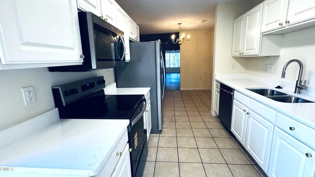 a kitchen with stainless steel appliances a sink stove and refrigerator