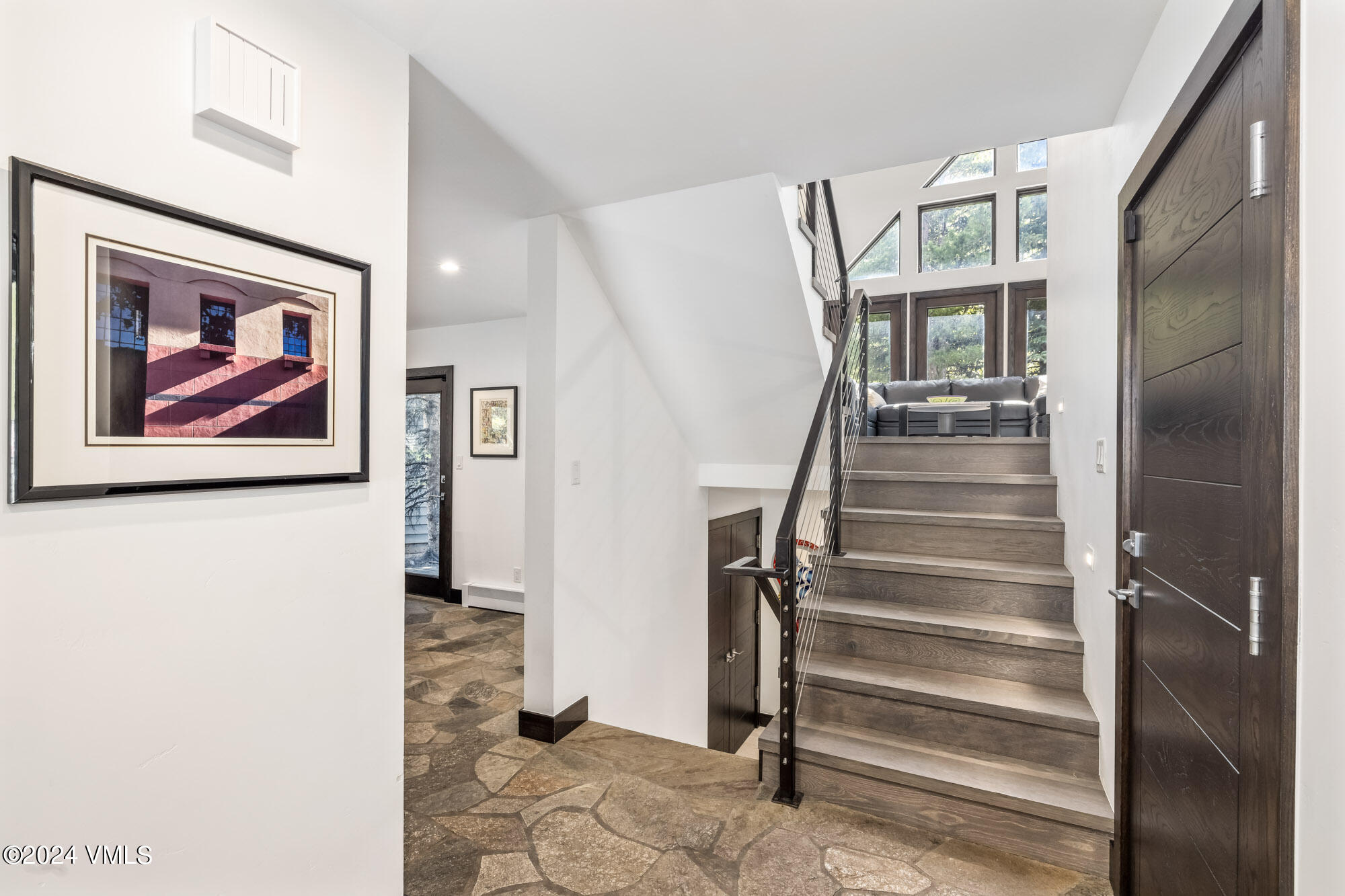 3891 Big Horn Road, Unit C Vail, CO 81657 - Photo 13 of 53 a view of a hallway with paintings on the wall