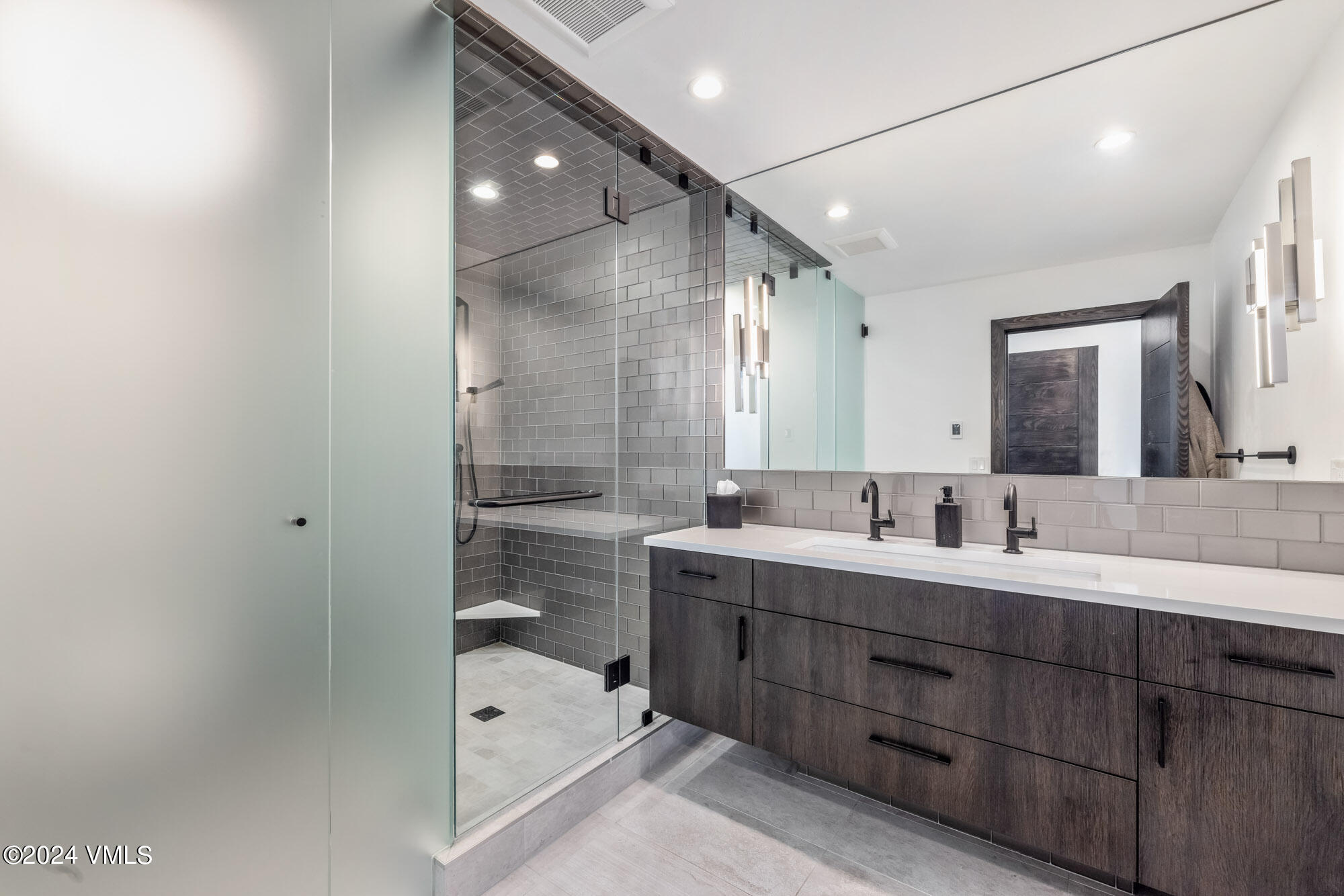 3891 Big Horn Road, Unit C Vail, CO 81657 - Photo 21 of 53 a bathroom with a double vanity sink a mirror and a bathtub