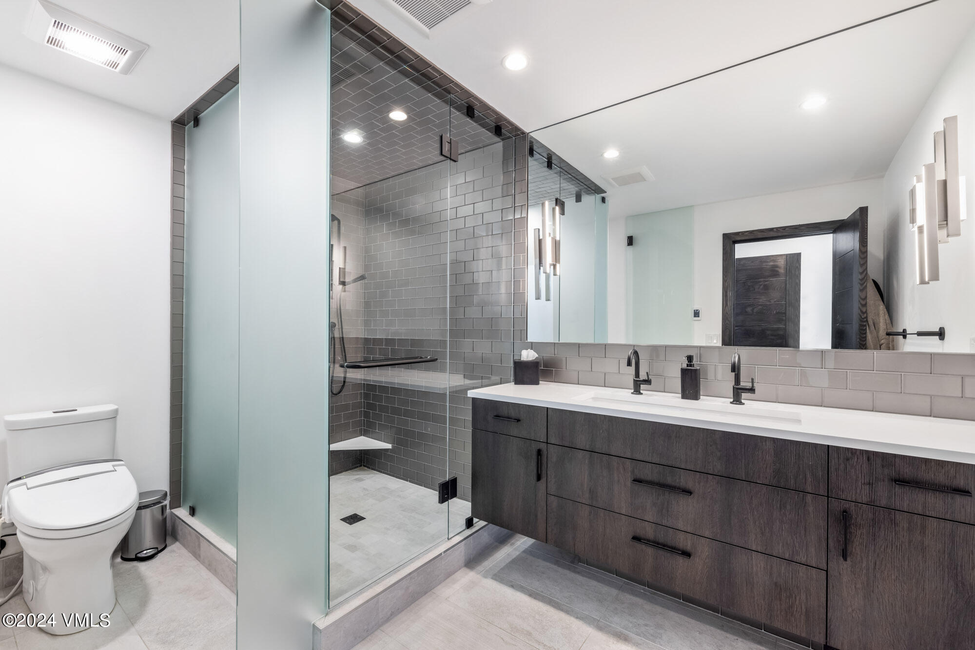 3891 Big Horn Road, Unit C Vail, CO 81657 - Photo 22 of 53 a bathroom with a double vanity sink mirror and toilet