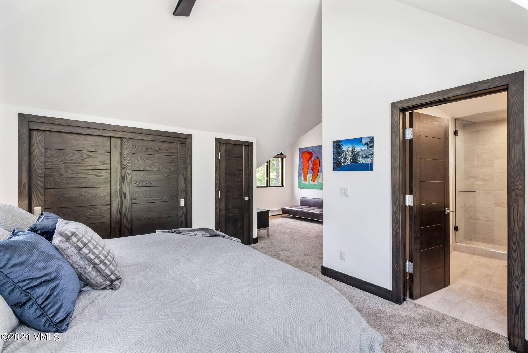 3891 Big Horn Road, Unit C Vail, CO 81657 - Photo 25 of 53 a bedroom with a large bed and a chandelier