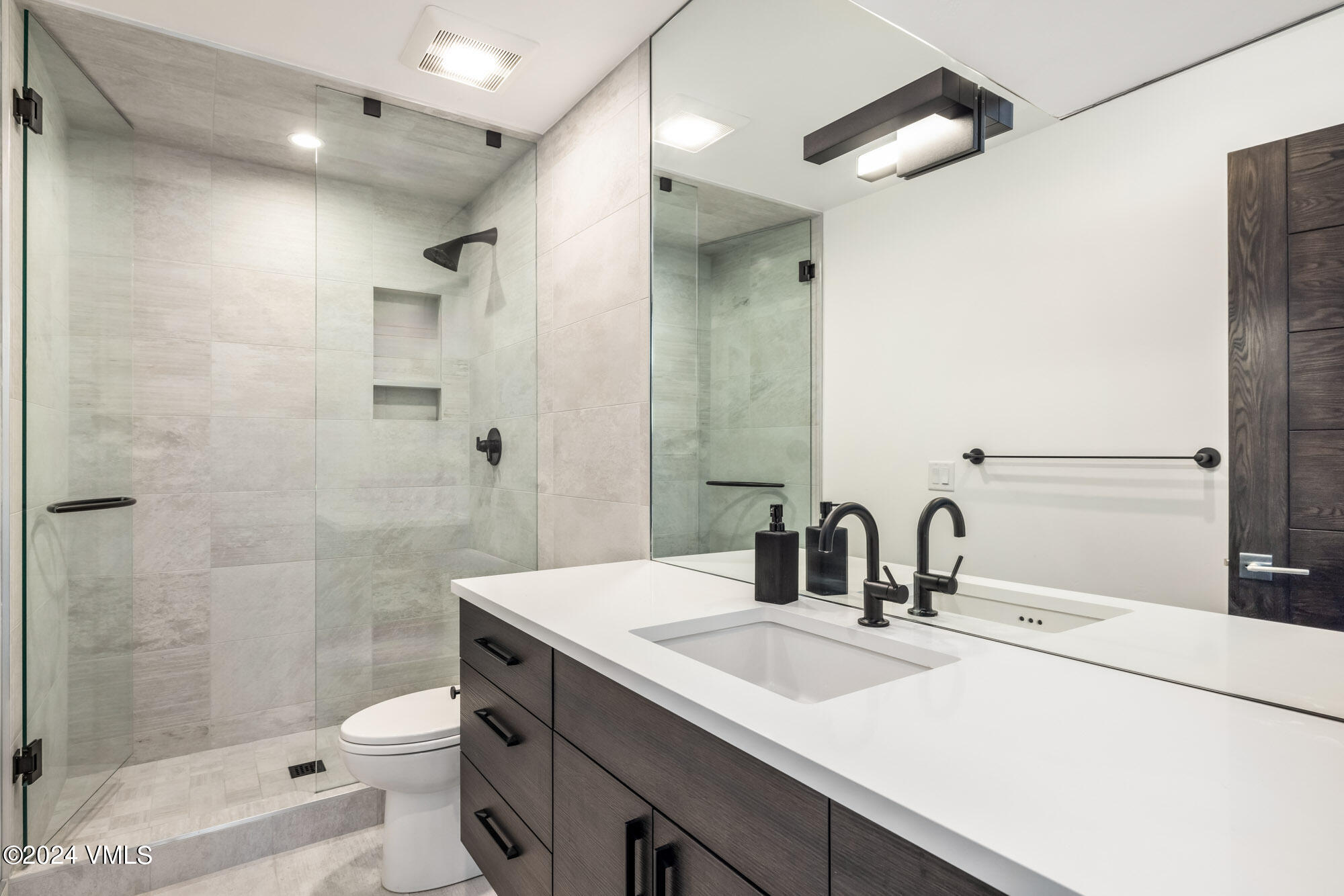 3891 Big Horn Road, Unit C Vail, CO 81657 - Photo 28 of 53 a bathroom with a sink toilet a mirror and shower