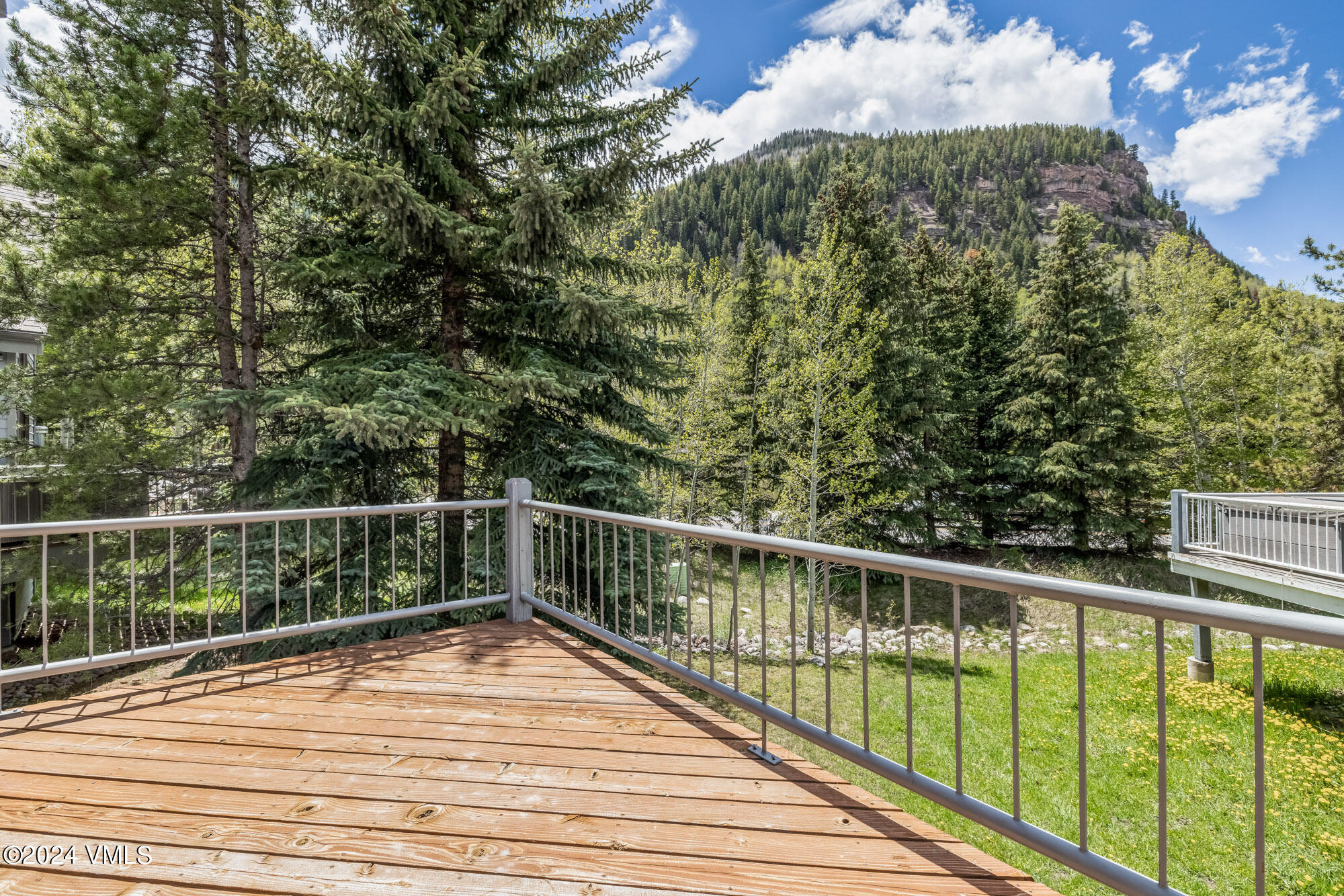 3891 Big Horn Road, Unit C Vail, CO 81657 - Photo 36 of 53 a view of a balcony with wooden floor and fence