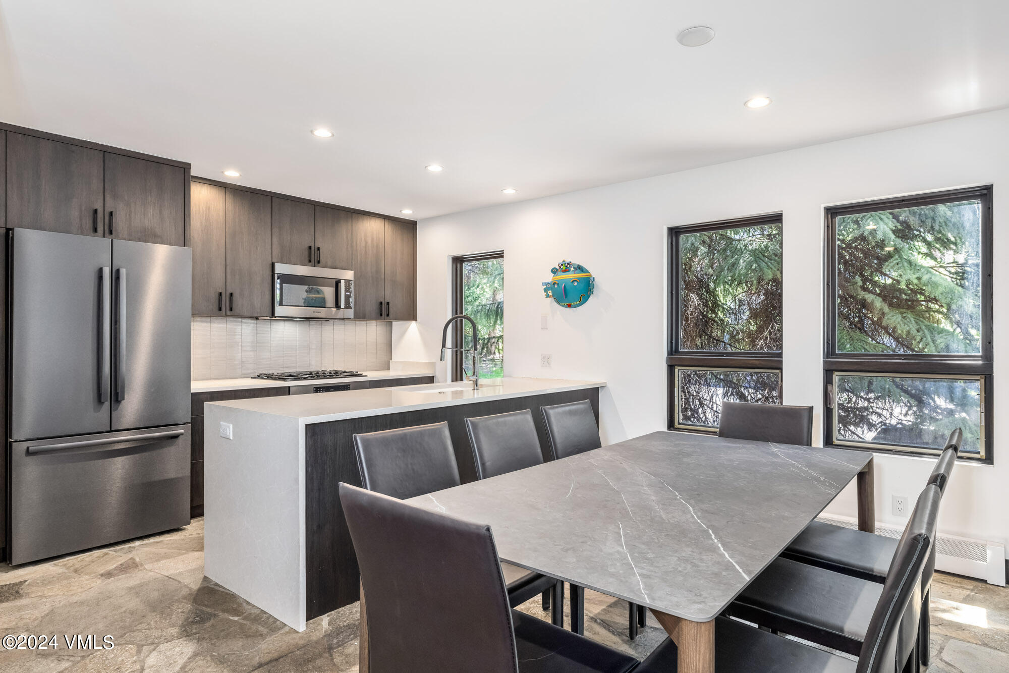 3891 Big Horn Road, Unit C Vail, CO 81657 - Photo 7 of 53 a kitchen with a table chairs refrigerator and microwave