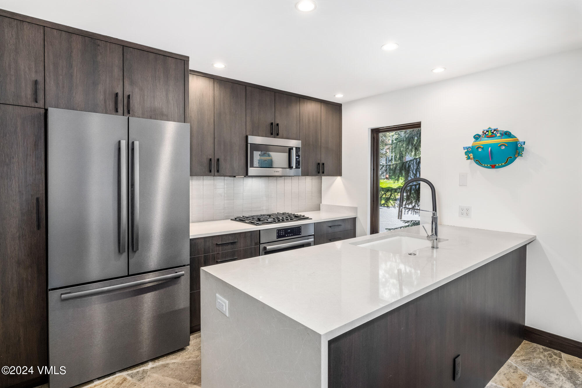 3891 Big Horn Road, Unit C Vail, CO 81657 - Photo 8 of 53 a kitchen with a refrigerator a sink stainless steel appliances and cabinets