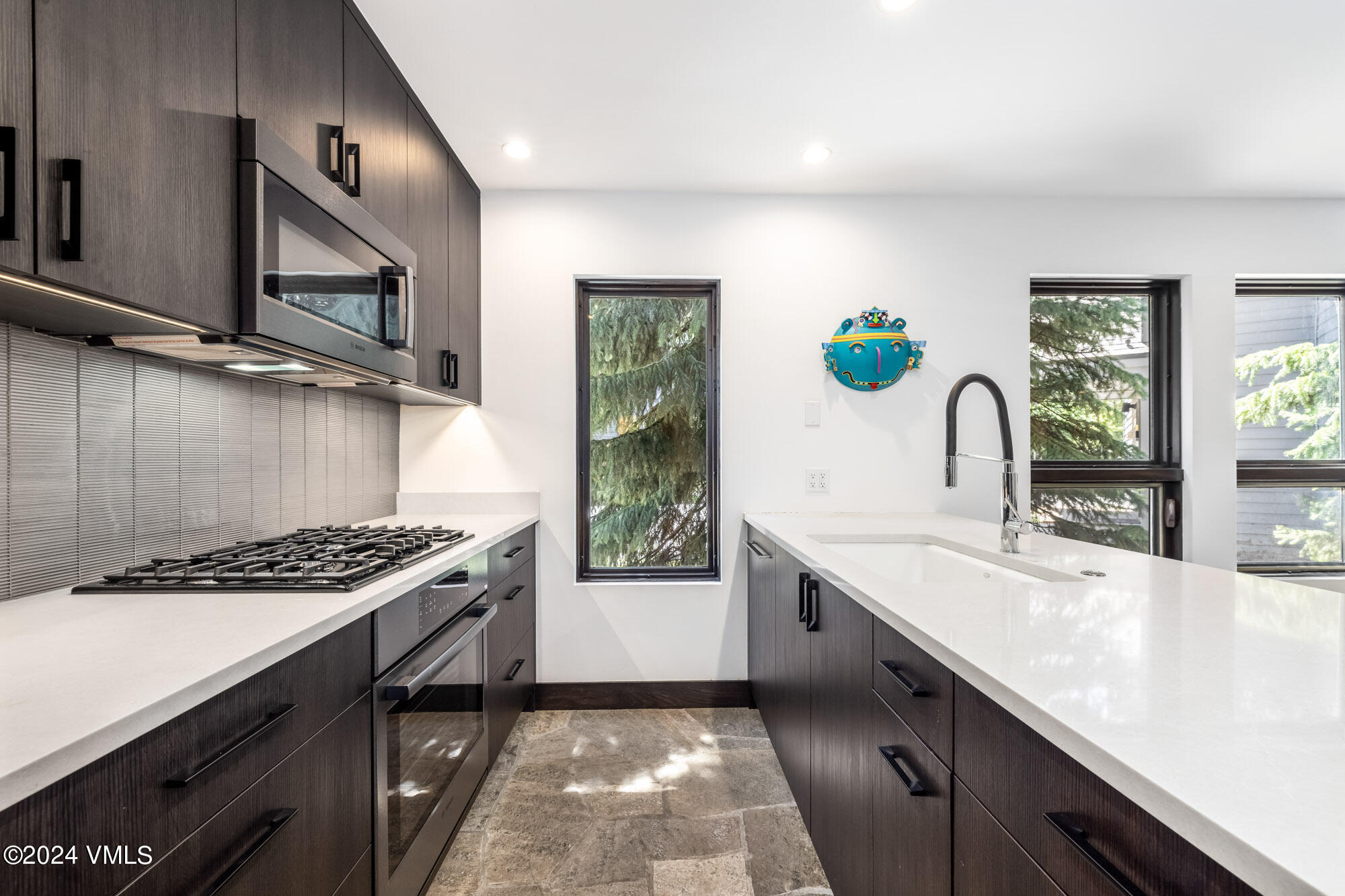 3891 Big Horn Road, Unit C Vail, CO 81657 - Photo 9 of 53 a kitchen with granite countertop a sink stove and cabinets