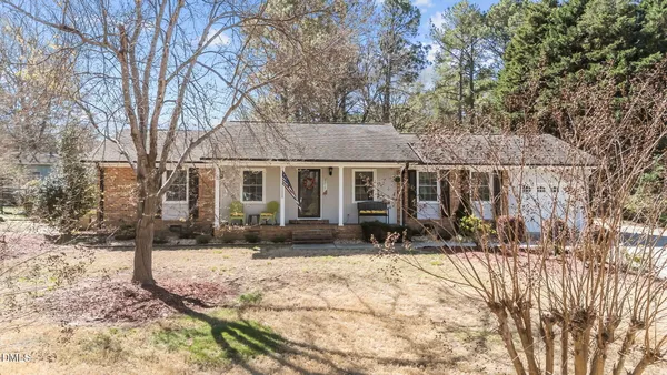 a front view of house with yard outdoor seating and barbeque oven