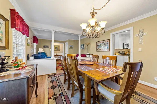a view of a dining room with furniture and a chandelier