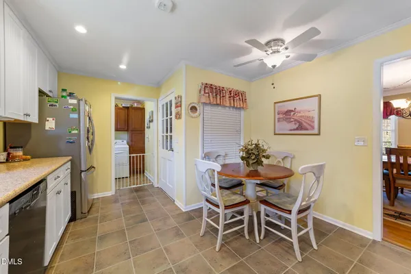 a view of a dining room with furniture and a chandelier