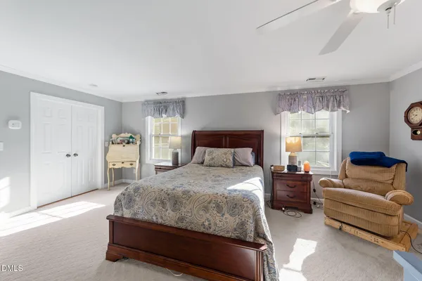 a bedroom with a bed couch and window