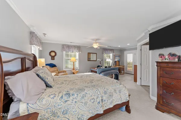 a bed room with a bed window and a flat screen tv
