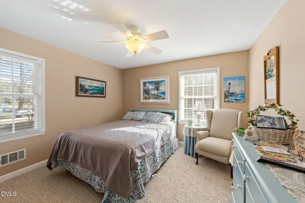 a bedroom with a large bed couch and a window