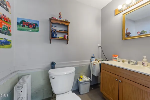 a bathroom with a toilet sink and mirror