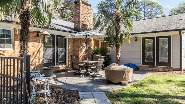 a couple of table and chairs in front of house