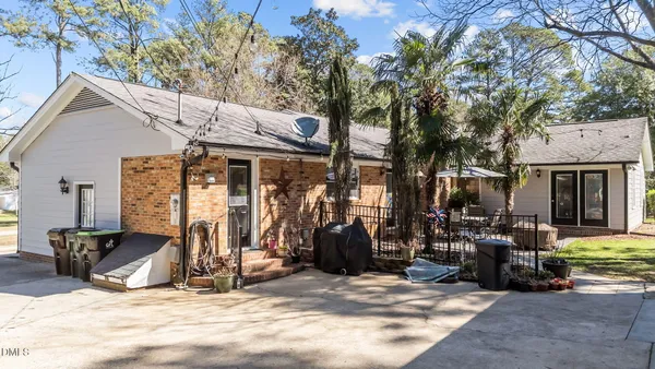 a view of a house with backyard porch and sitting area