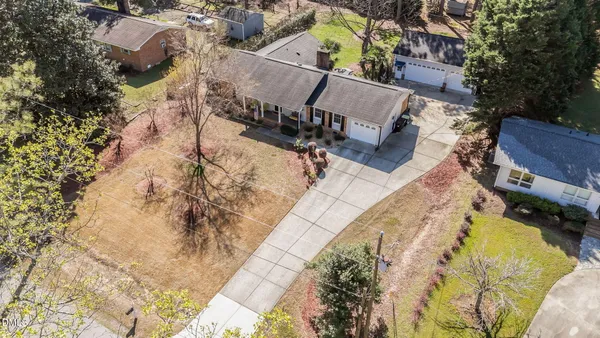 an aerial view of a house with swimming pool and sitting area