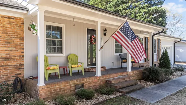 a backyard of a house with yard and outdoor seating