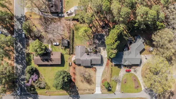 an aerial view of a house with a yard basket ball court and outdoor seating