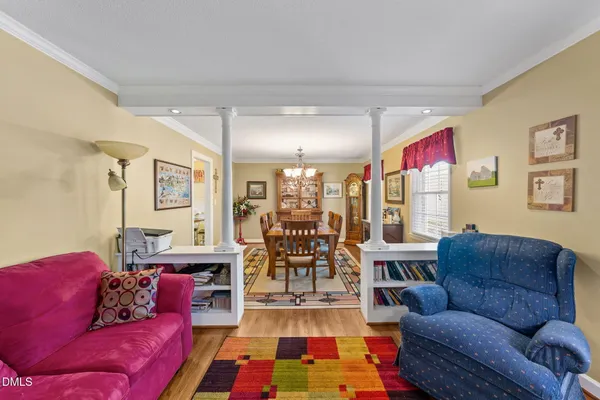 a living room with furniture and a chandelier