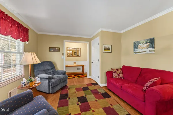 a living room with furniture and a lamp