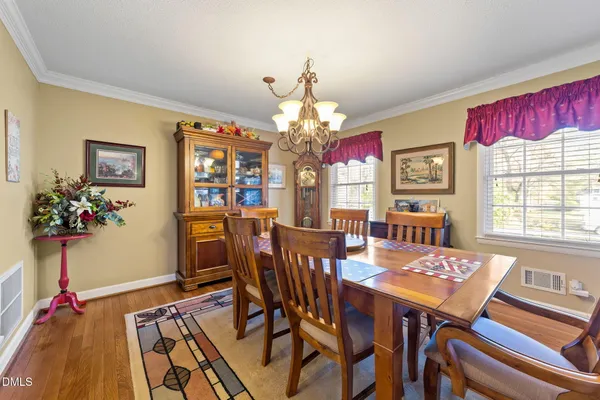 a view of a dining room with furniture and a chandelier