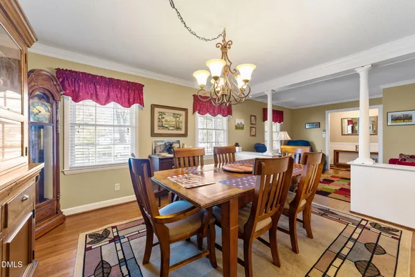 a view of a dining room with furniture window and wooden floor