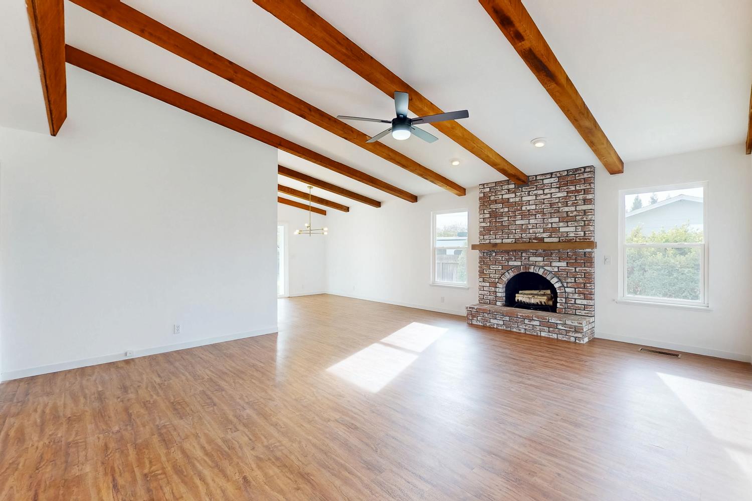 7830 Griffith Lane Sutter, CA 95982 - Photo 13 of 69 a view of an empty room with wooden floor fireplace and a window