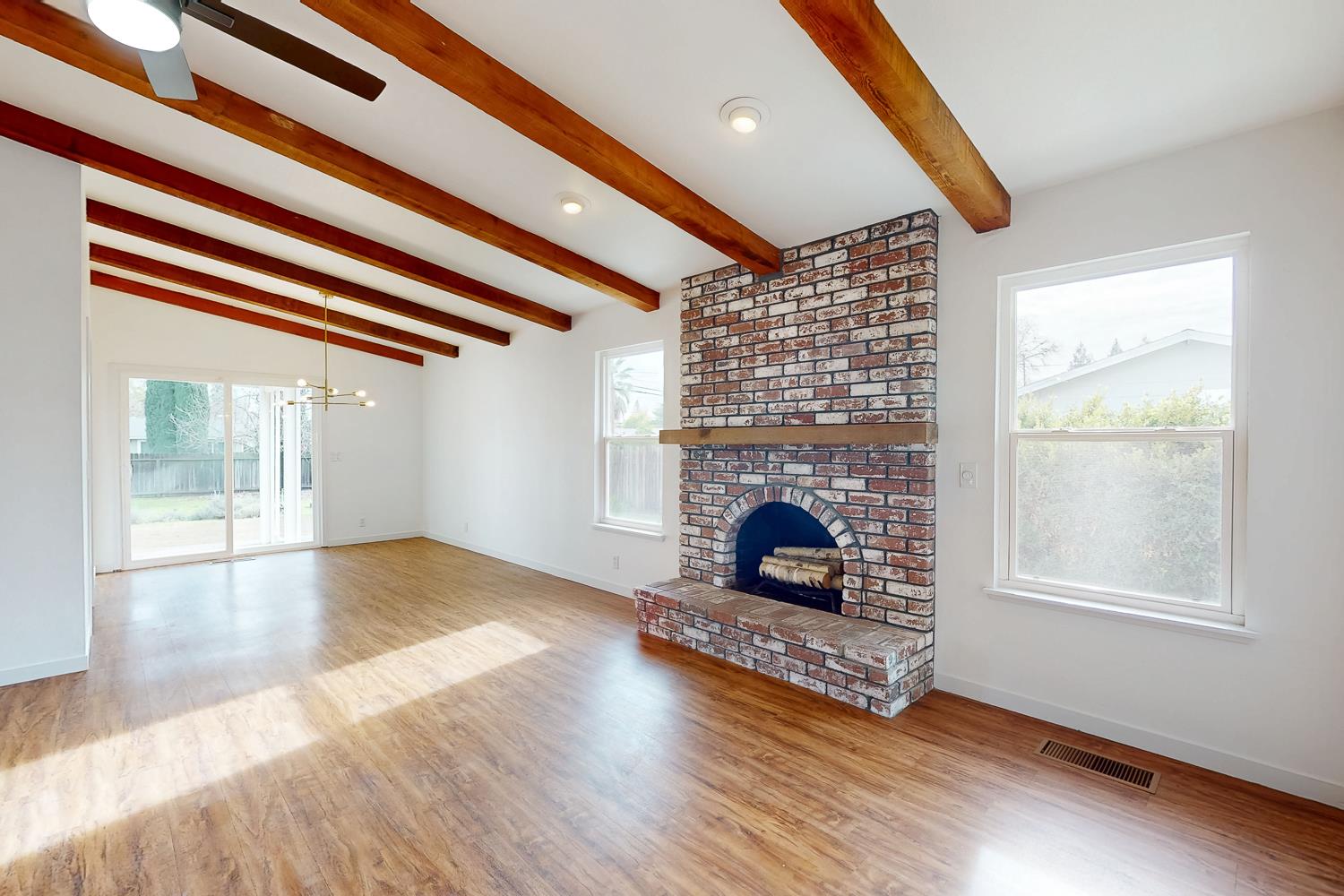 7830 Griffith Lane Sutter, CA 95982 - Photo 14 of 69 a view of an empty room with wooden floor fireplace and a window