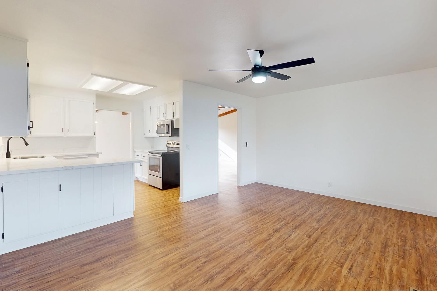 7830 Griffith Lane Sutter, CA 95982 - Photo 22 of 69 a view of a kitchen with wooden floor and a kitchen space