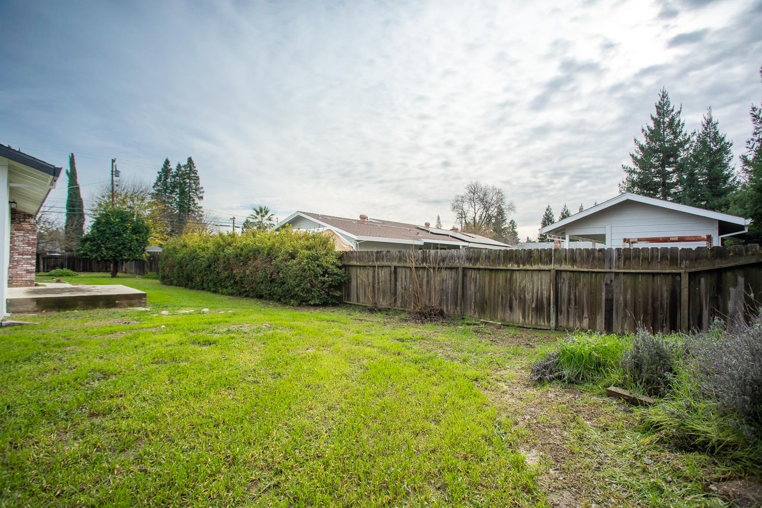 7830 Griffith Lane Sutter, CA 95982 - Photo 56 of 69 a view of a backyard with potted plants and wooden fence