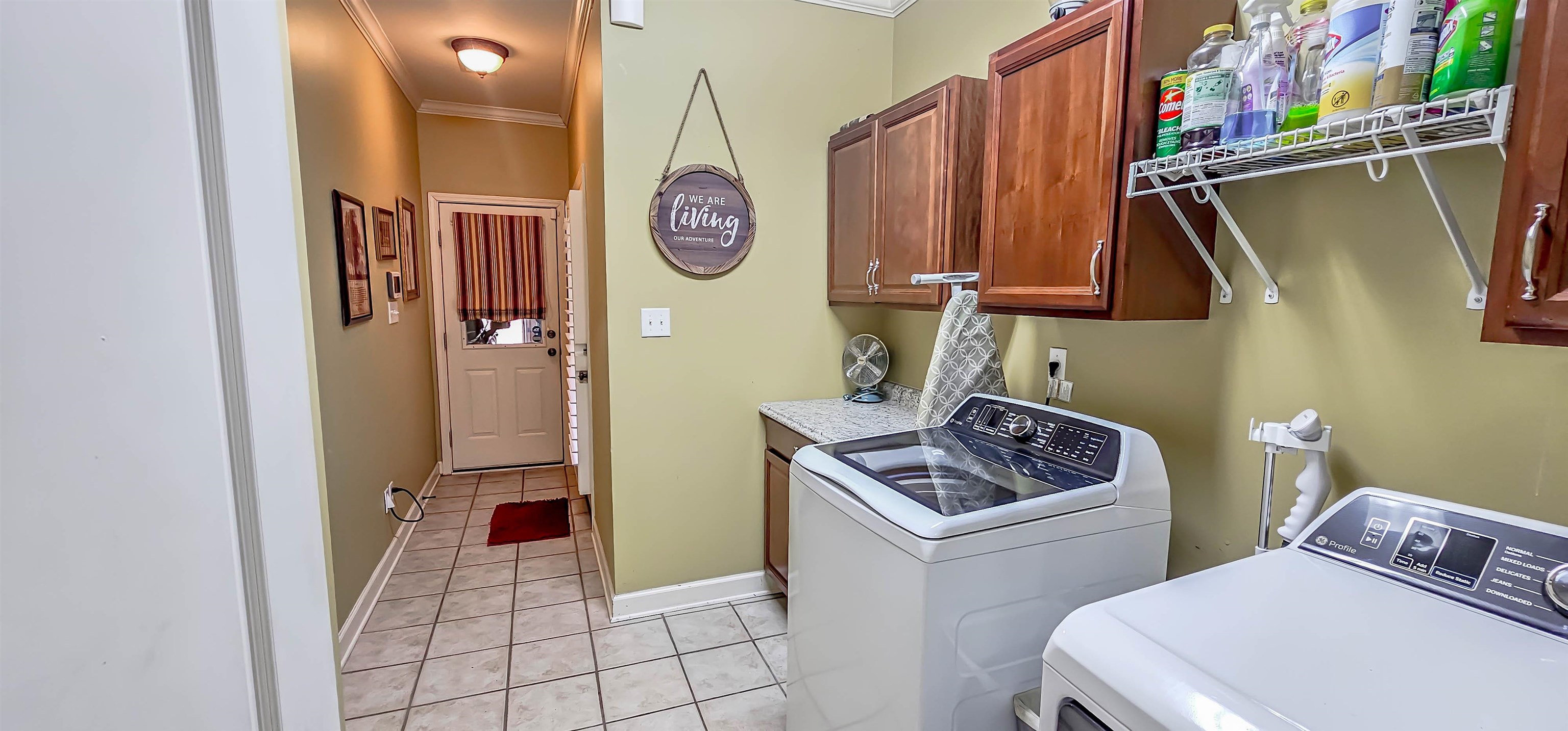 824 McFerrin Lane Collierville, TN 38017 - Photo 15 of 25 Laundry area with crown molding, independent washer and dryer, light tile patterned floors, and cabinet space