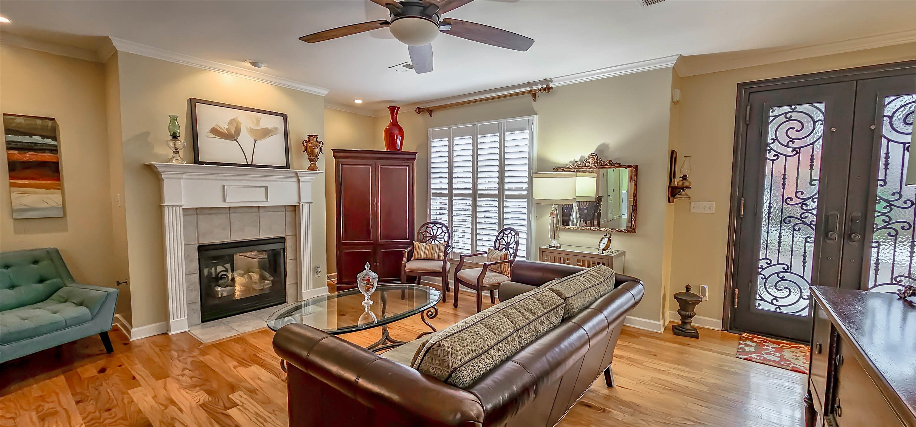824 McFerrin Lane Collierville, TN 38017 - Photo 7 of 25 Living room with french doors, ornamental molding, light wood-style floors, ceiling fan, and a fireplace