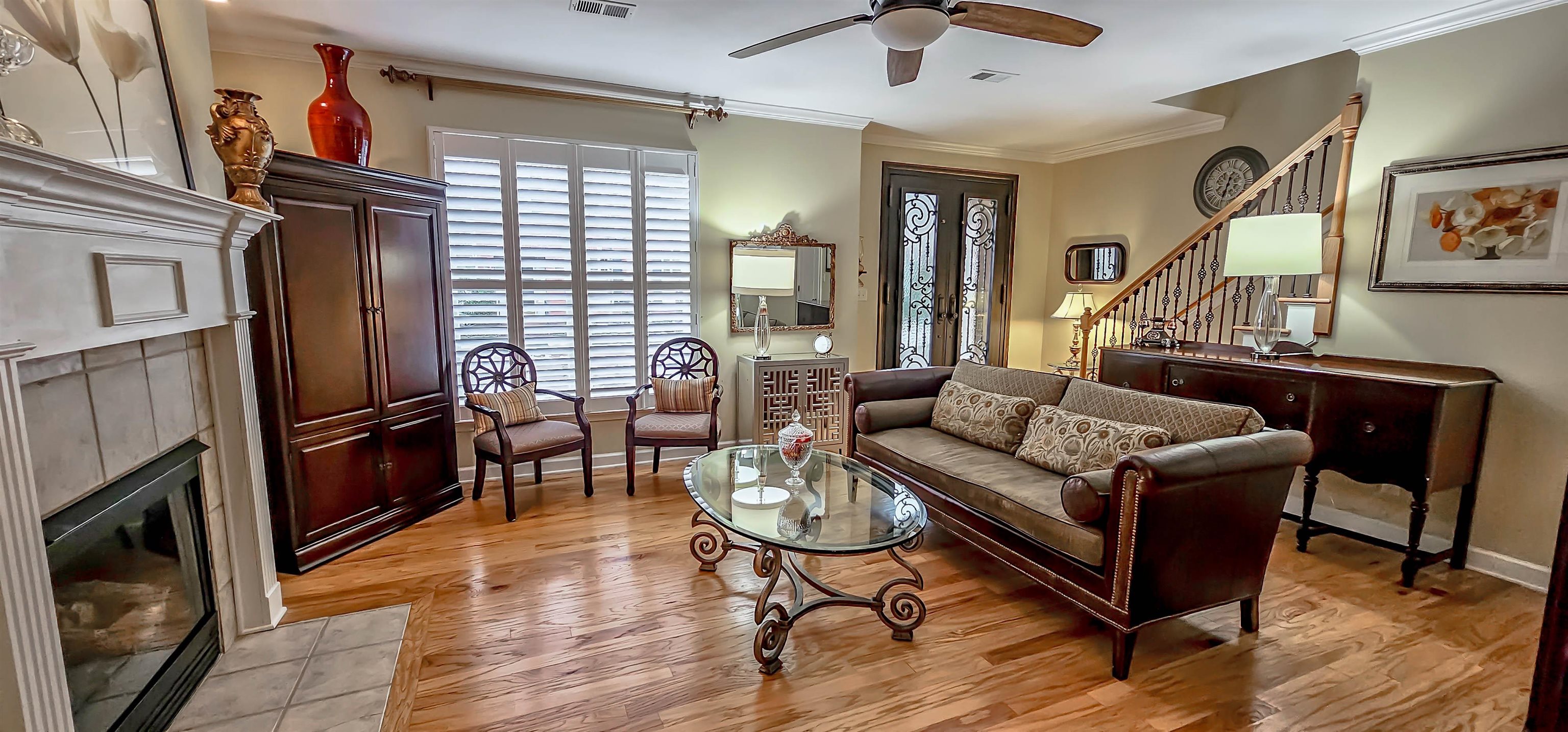 824 McFerrin Lane Collierville, TN 38017 - Photo 8 of 25 Living area with crown molding, light wood-style flooring, a tiled fireplace, and ceiling fan