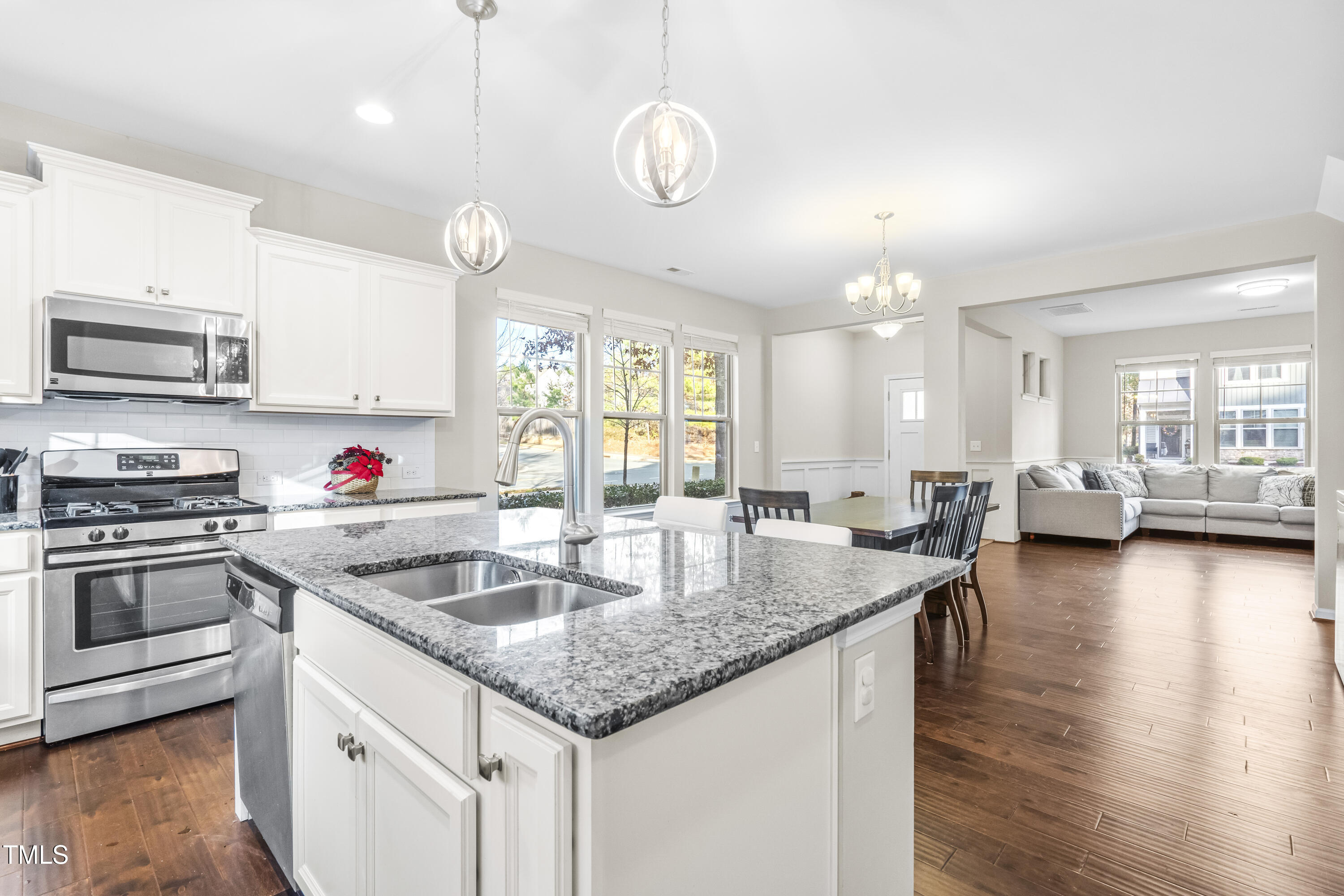 1004 Metropolitan Drive Durham, NC 27713 - Photo 6 of 28 a kitchen with stainless steel appliances granite countertop a sink dishwasher a stove and a microwave oven with wooden floor