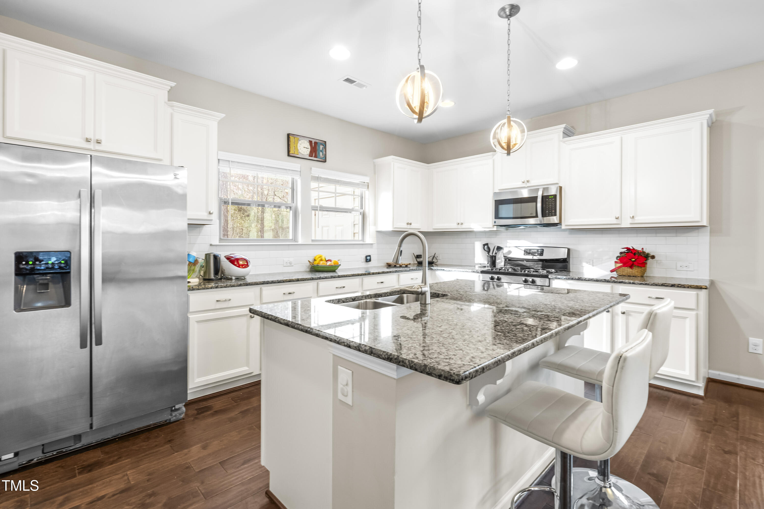 1004 Metropolitan Drive Durham, NC 27713 - Photo 7 of 28 a kitchen with stainless steel appliances granite countertop a sink a refrigerator and a stove