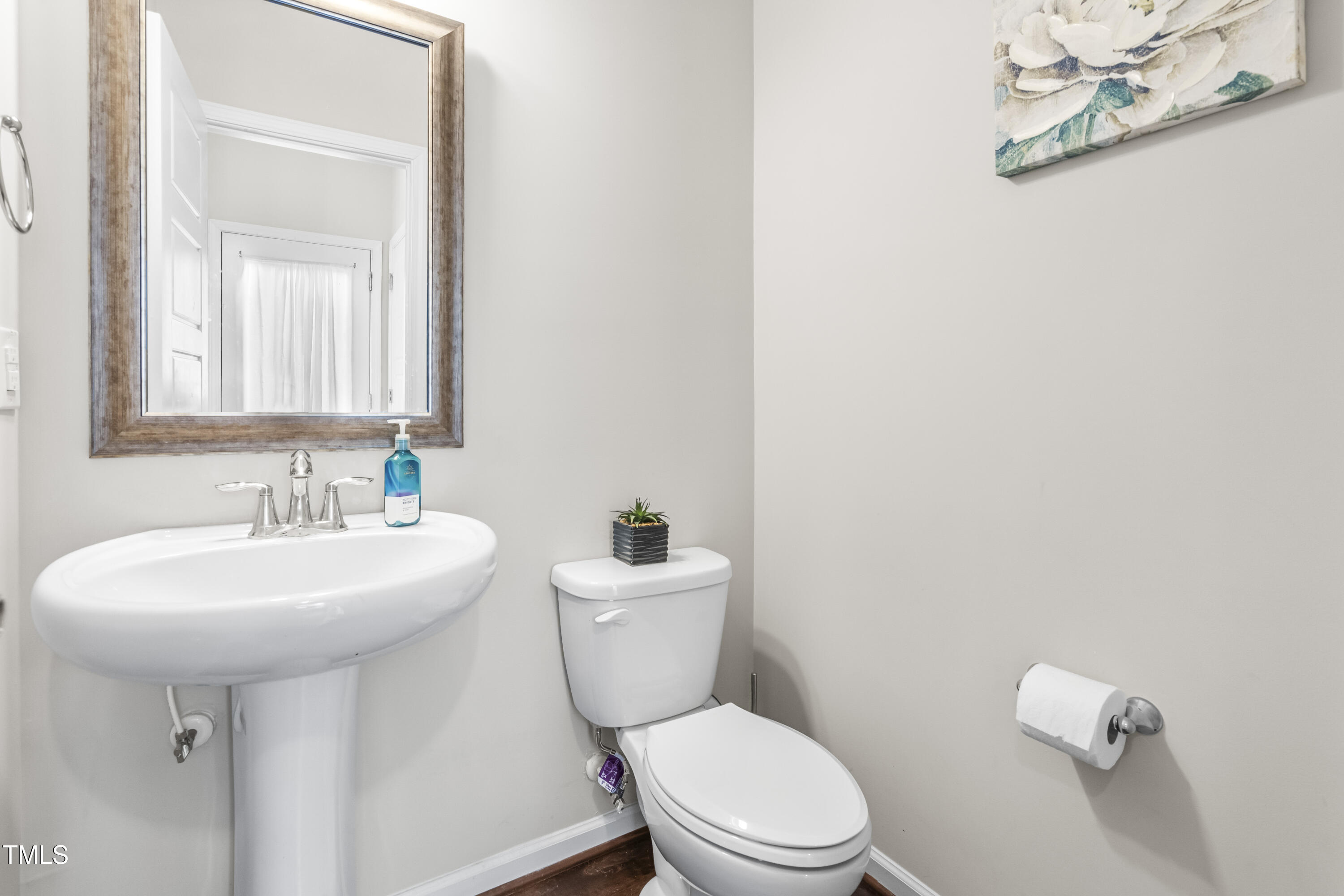 1004 Metropolitan Drive Durham, NC 27713 - Photo 9 of 28 a bathroom with a sink a toilet and mirror