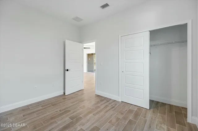 an empty room with wooden floor