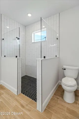 a bathroom with a toilet and a shower