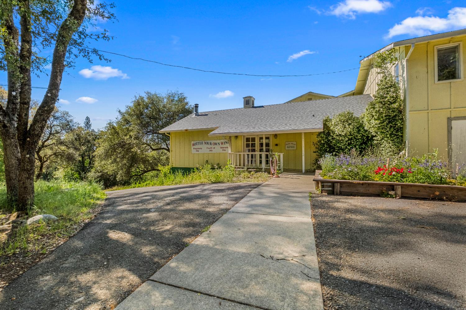 8221 Stoney Creek Road Somerset, CA 95684 - Photo 18 of 44 a front view of a house with a yard and garage