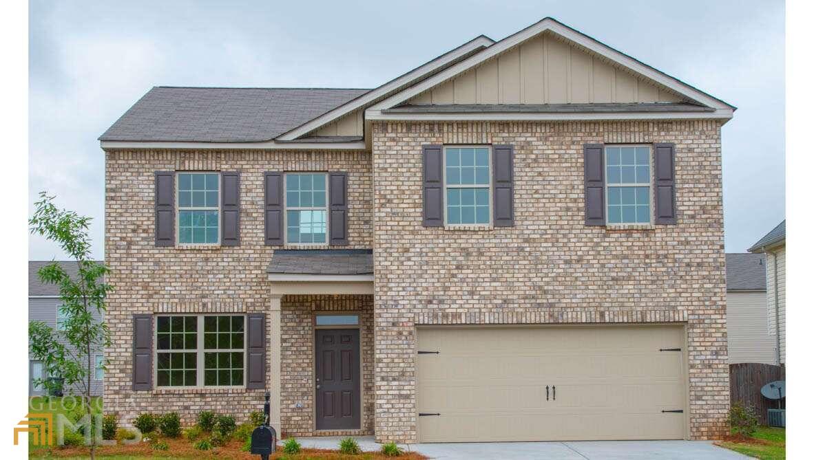 237 Montgomery Drive, Unit 75 Stockbridge, GA 30281 - Photo 1 of 1 a front view of a house with a yard and garage