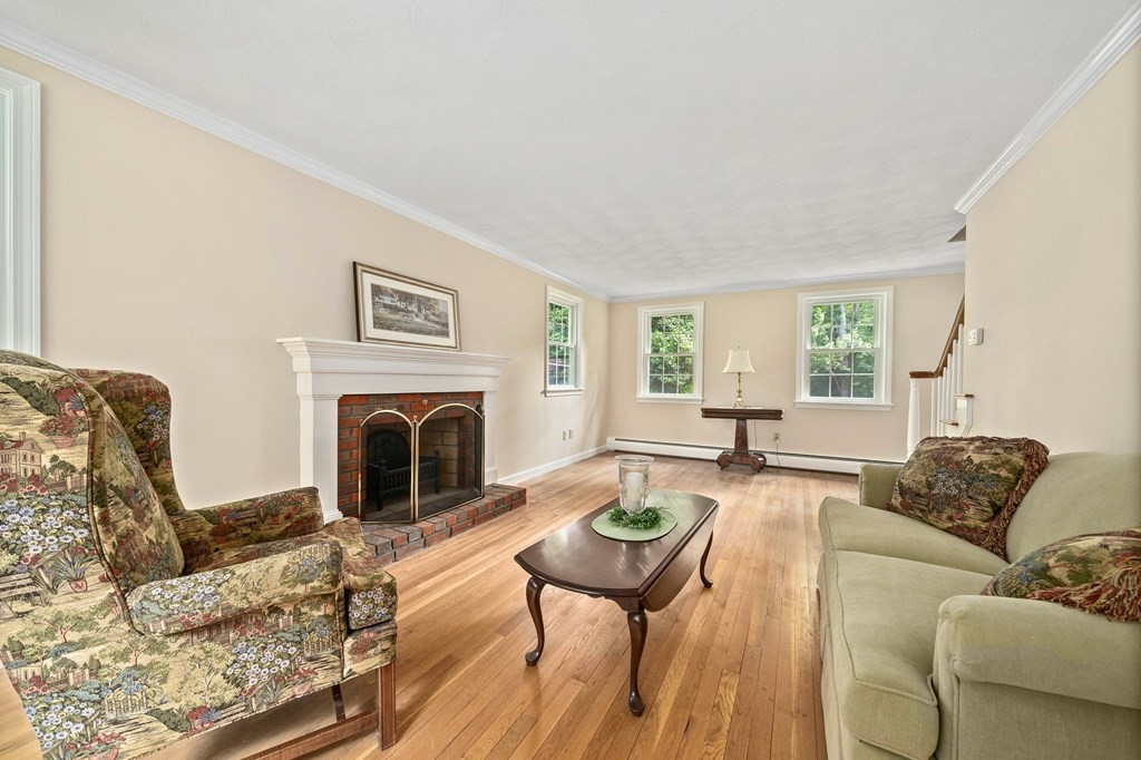 116 Meadowbrook Road Hanover, MA 02339 - Photo 19 of 41 a living room with furniture a fireplace a table and a large window