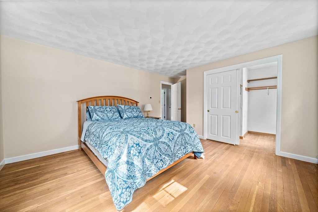 116 Meadowbrook Road Hanover, MA 02339 - Photo 22 of 41 a bedroom with a bed and wooden floor