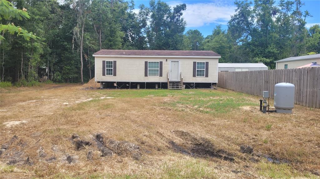 13144 Southwest 18th Street Road Ocala, FL 34481 - Photo 20 of 20 a view of a house with backyard and trees