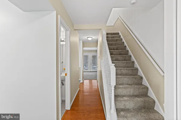 a view of a hallway with wooden floor and entryway