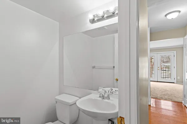 a bathroom with a toilet a sink and mirror