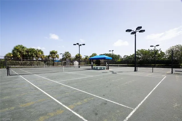 a kitchen with stainless steel appliances granite countertop a stove a sink a microwave and a dining table